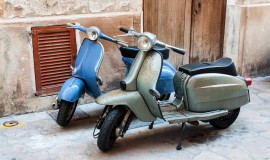 Two vintage scooter parked in the street
